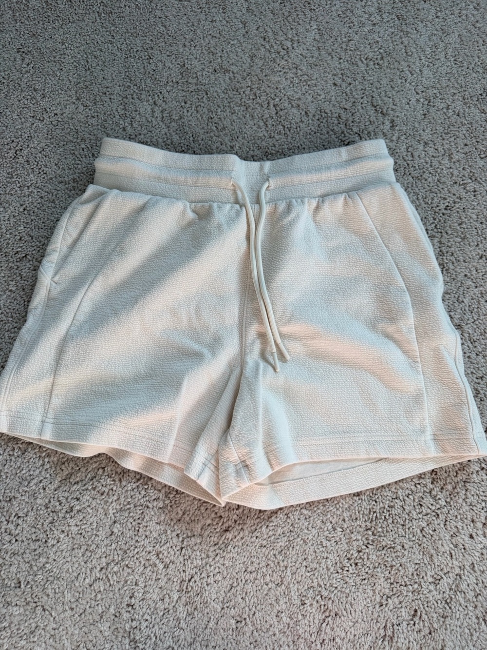 Danskin cream shorts with subtle textured weave, size S